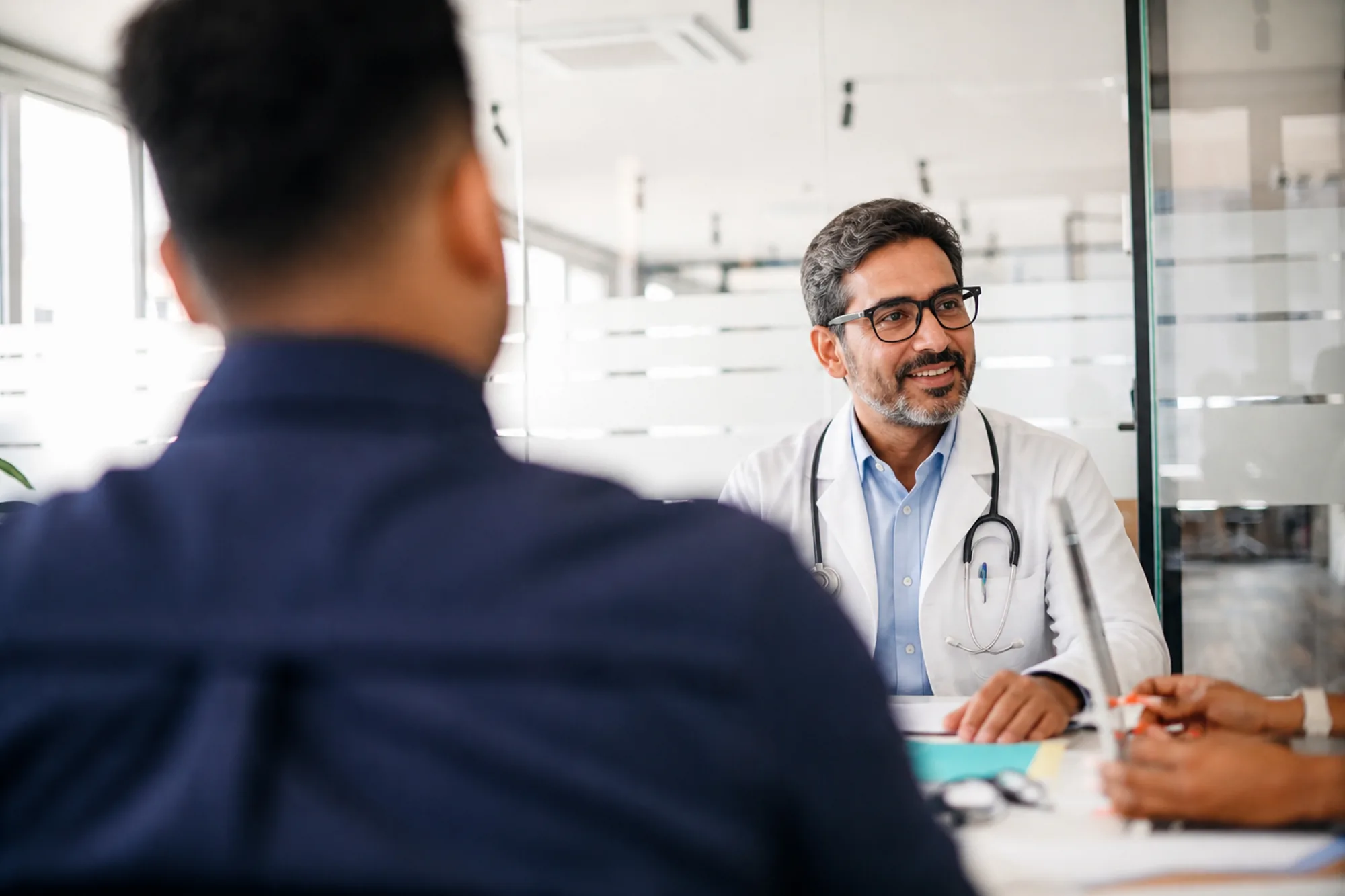 Muslim doctor speaking with investment advisor